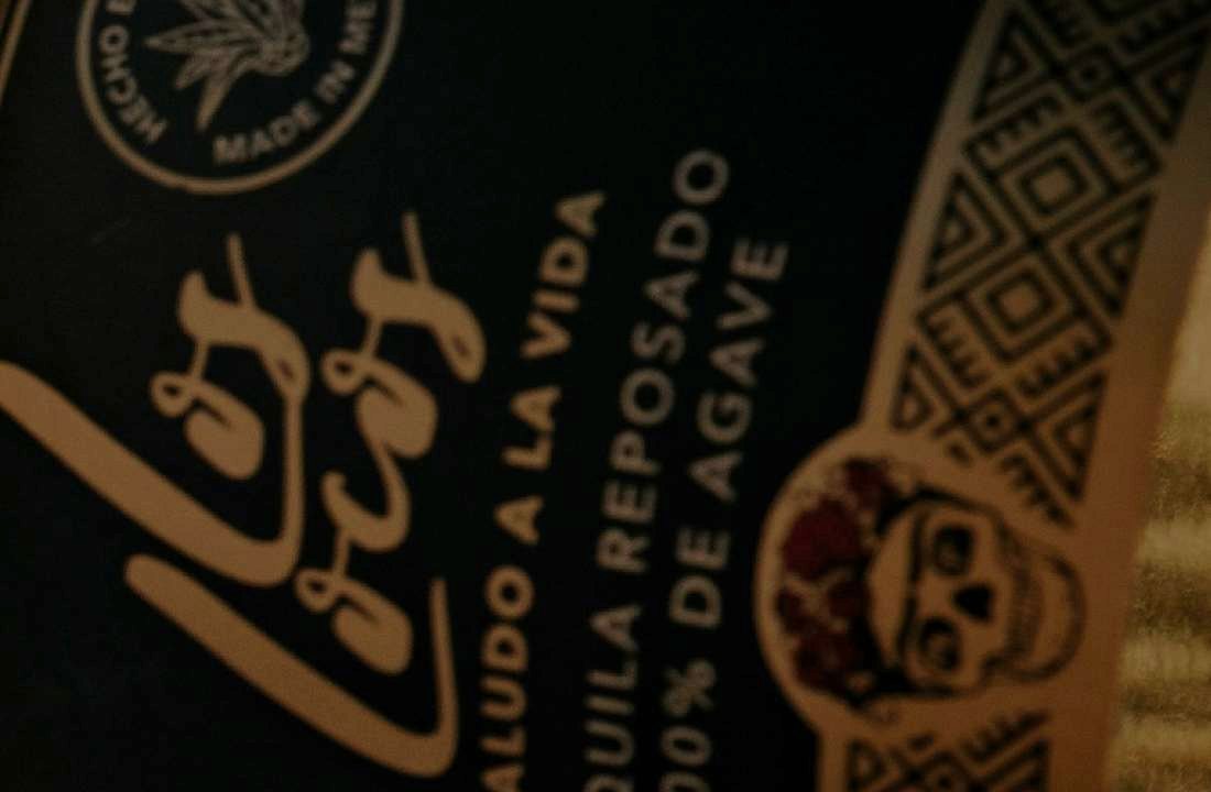 Los Locos bottle label with the skull emblem and Mexican pattern